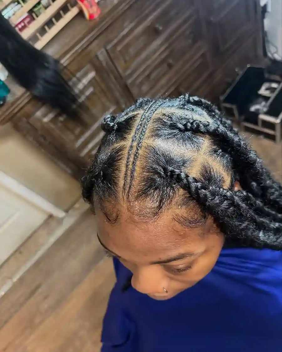 Person with braided hair in a kitchen setting