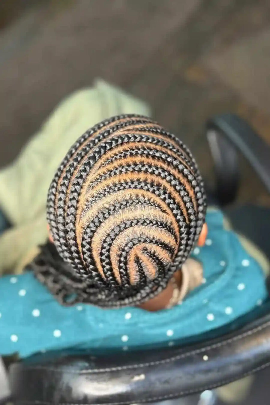 Textured ball with black and orange pattern on a teal surface