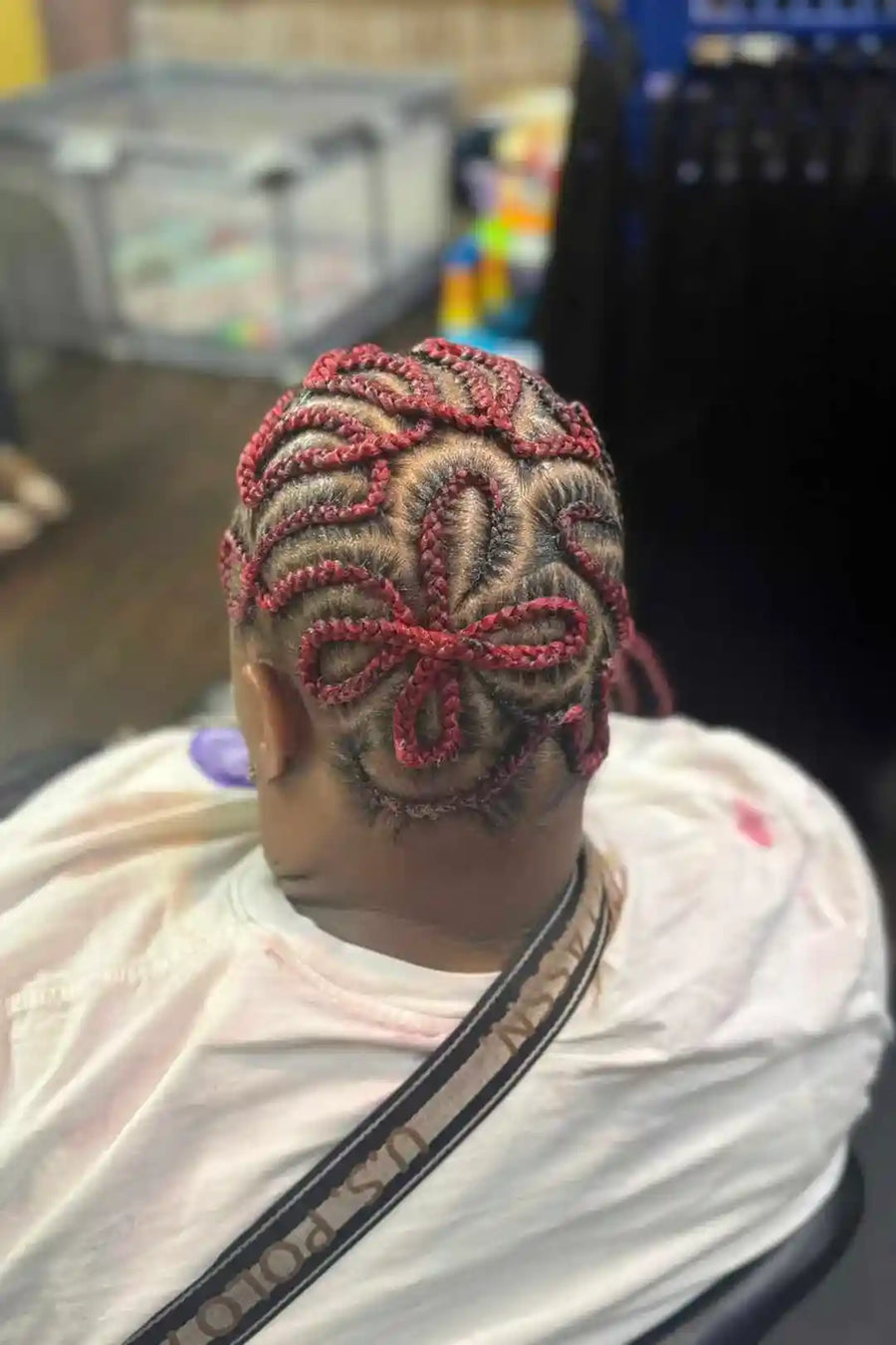 Person with intricate hair design in a store setting