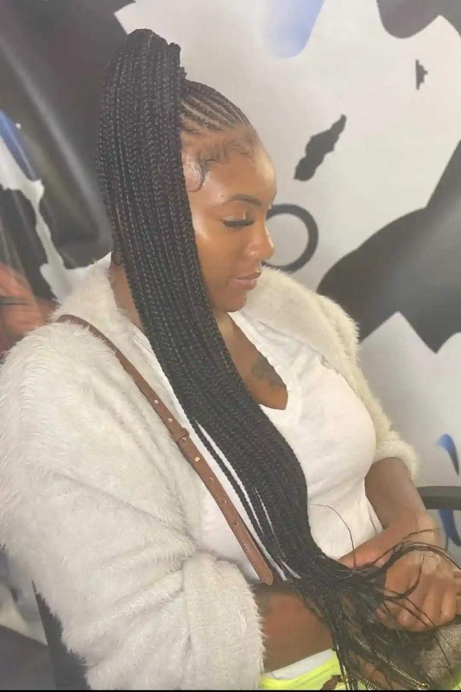 Woman with braided hair sitting in a car