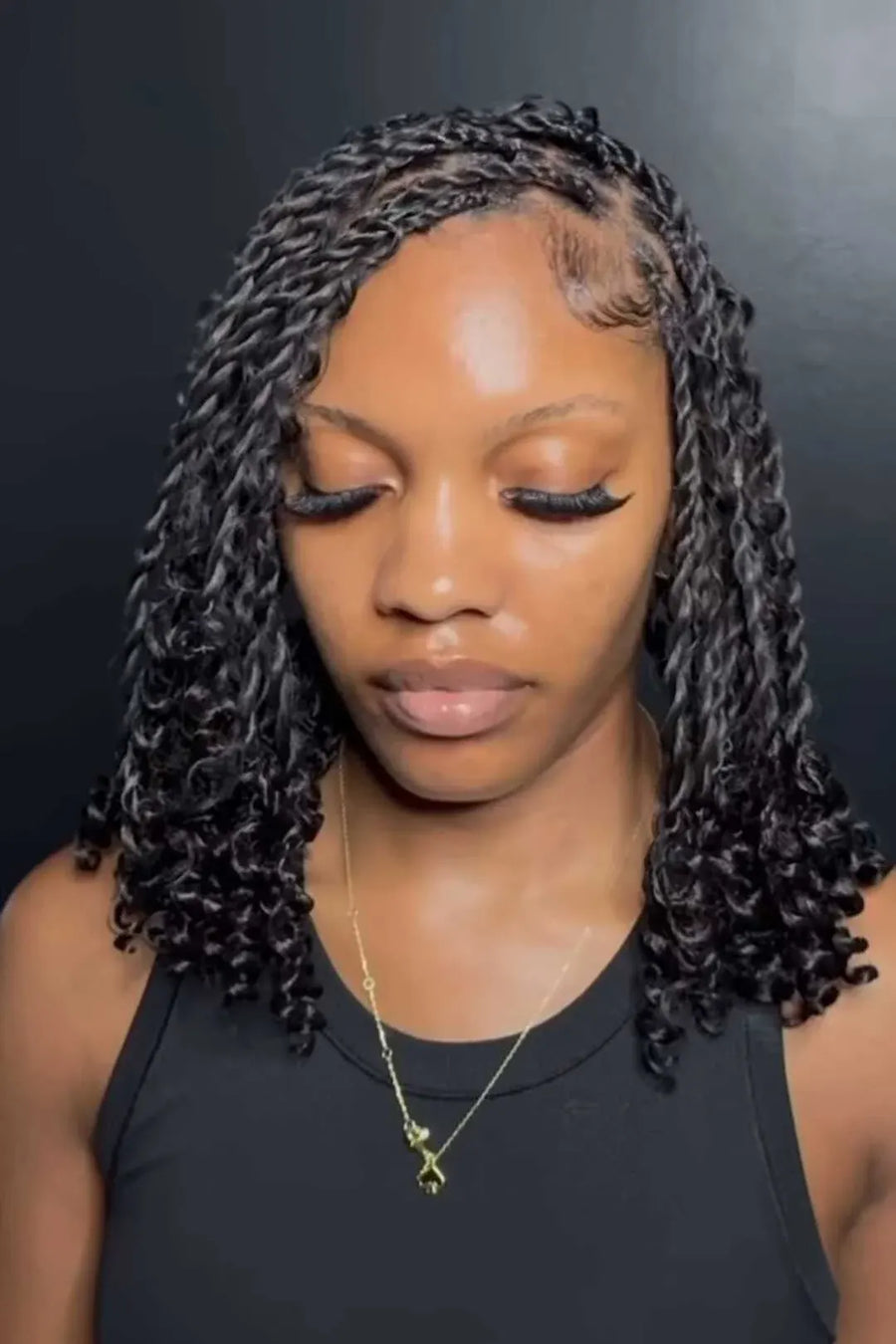 Woman with styled hair against a dark background