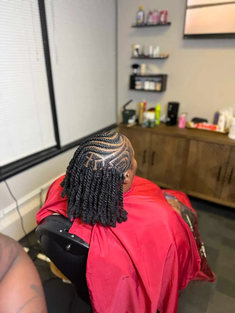 Person with styled braids in a salon setting