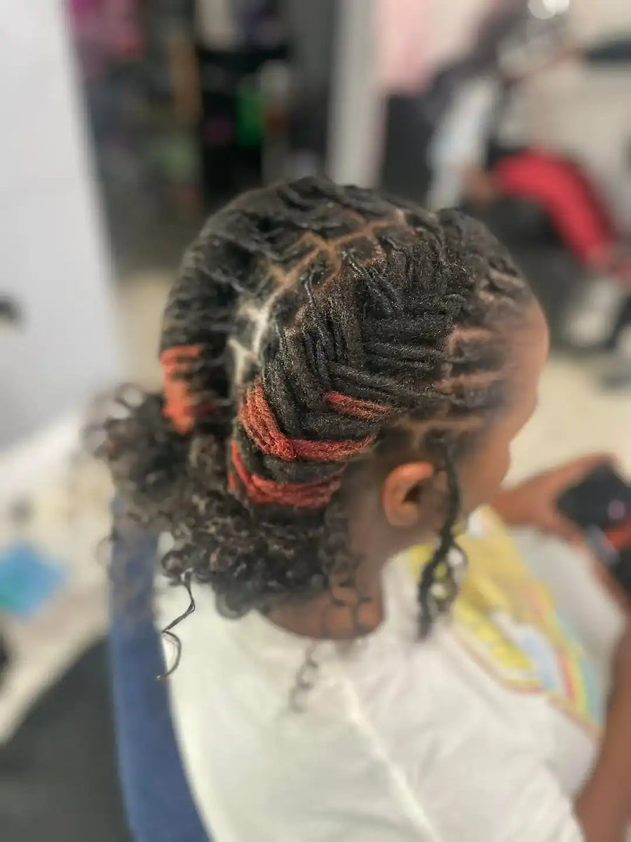 Person with braided hair in a salon setting