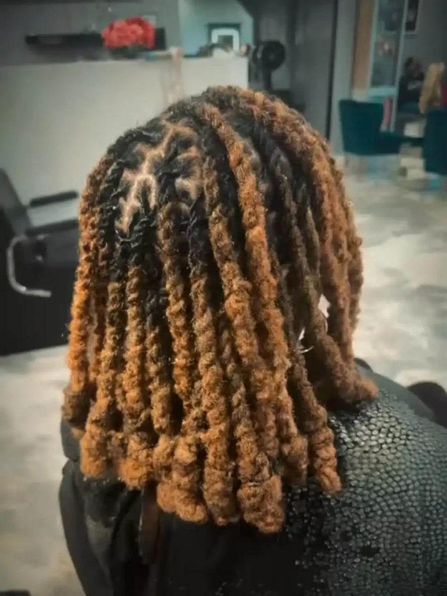 Person with styled dreadlocks in a salon setting