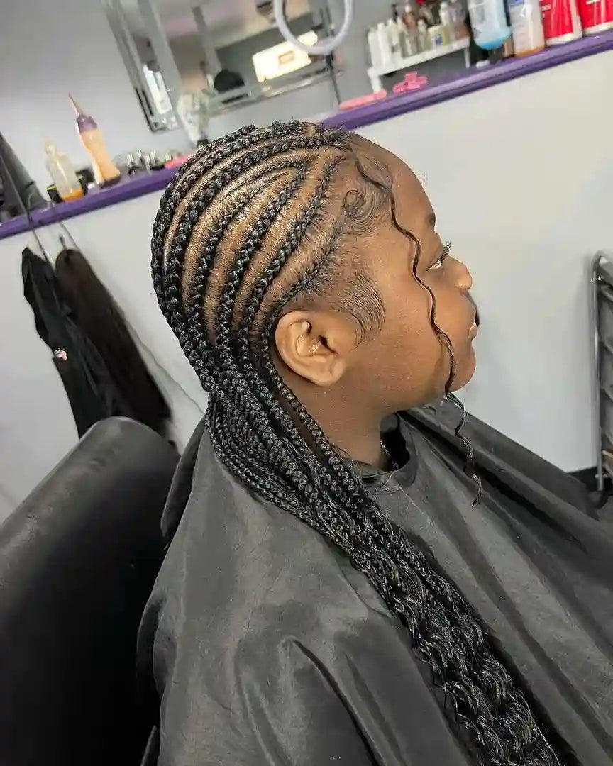 Person with braided hair in a salon setting