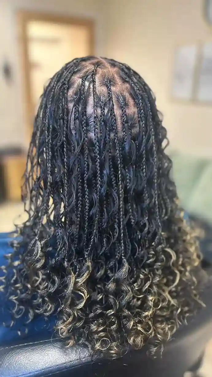 Close-up of a person with styled braids in a salon setting