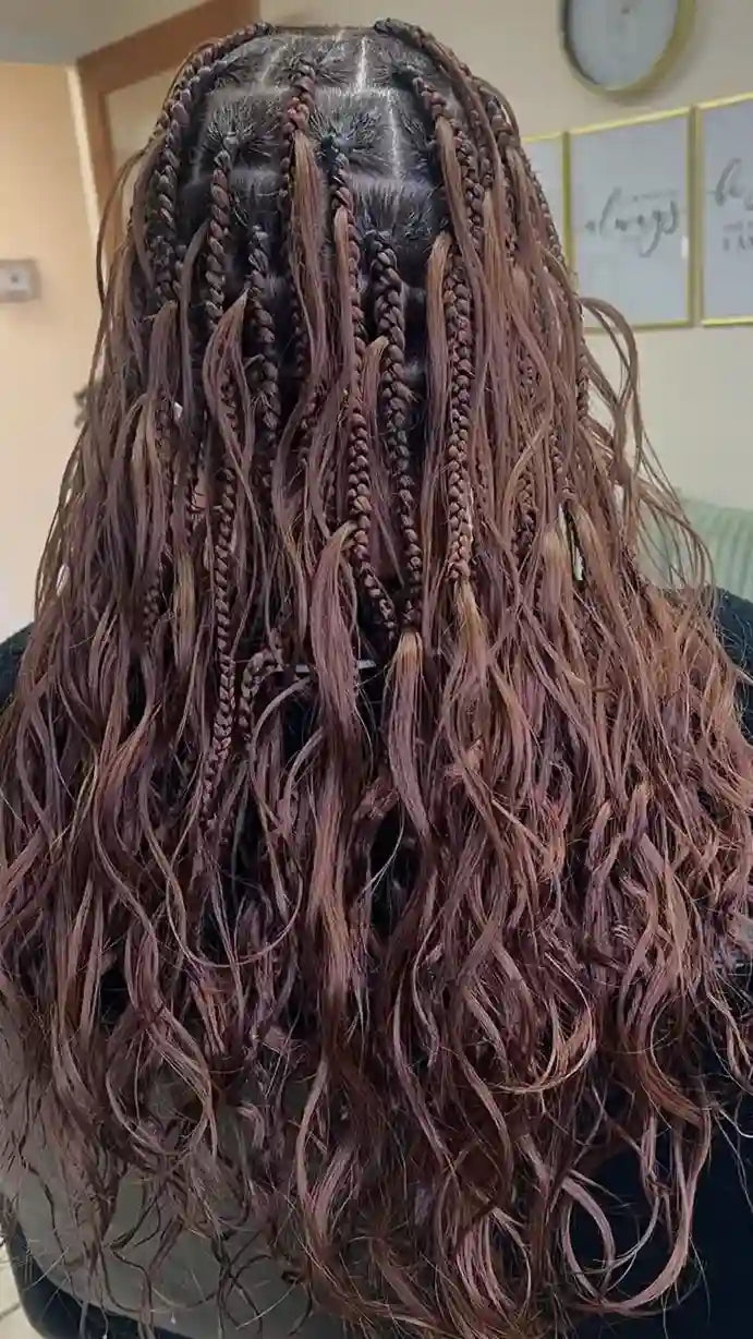 Mannequin head with long, wavy hair extensions in a room setting.
