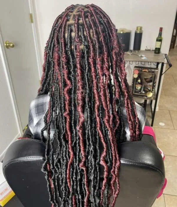 Textured fabric roll with pink and black patterns on a chair in a kitchen setting