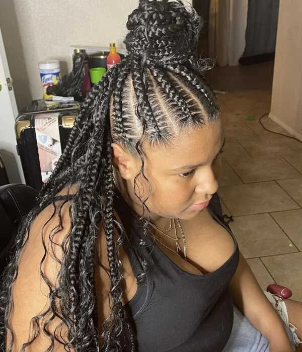 Person with braided hair in a kitchen setting