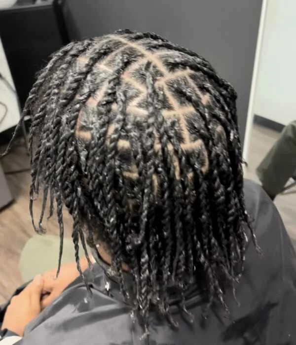 Person with braided hair in a salon setting