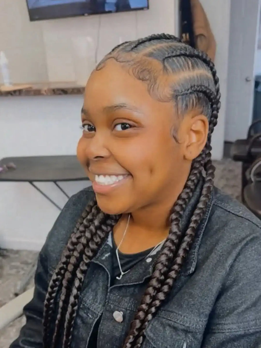 Person with styled braids in an indoor setting