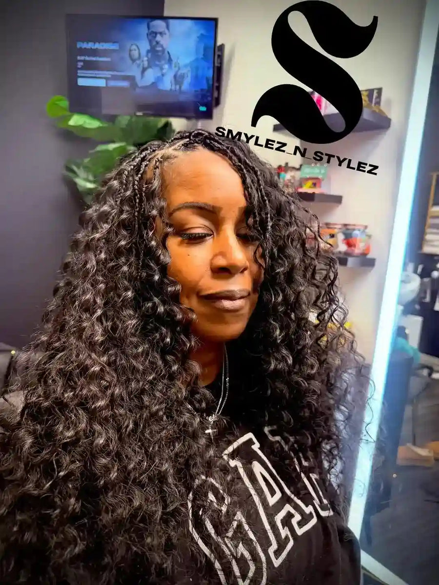 Woman with styled hair in a salon setting with 'Smylez N Stylez' branding.