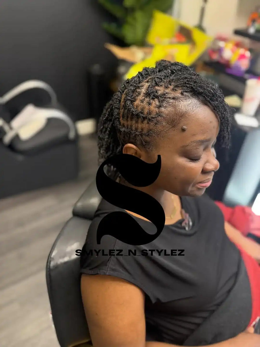 Person with styled hair sitting in a salon chair, with 'Smylez N Stylez' branding.