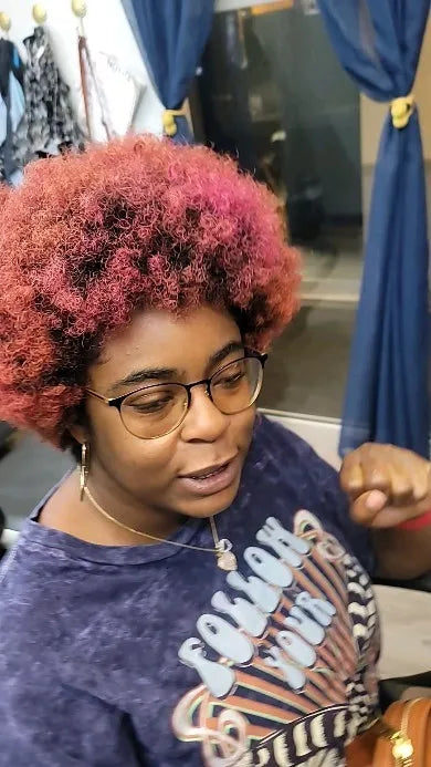 Short pink curly afro hairstyle, Stylist located in Atlanta, GA