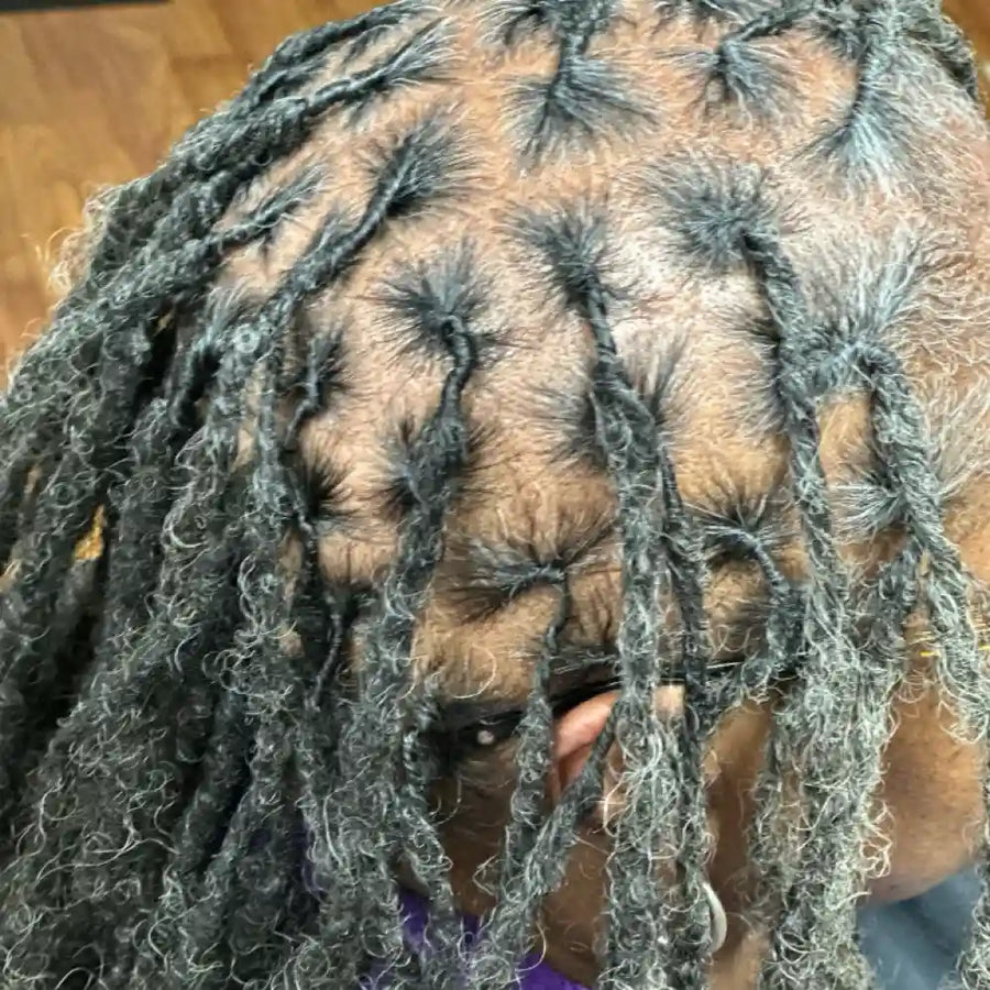 Close-up of a person with braided hair, focusing on the texture and detail.