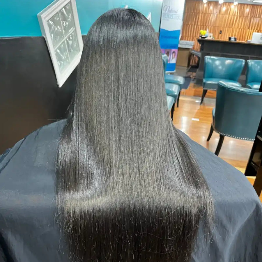 Person with long, straight hair in a salon setting