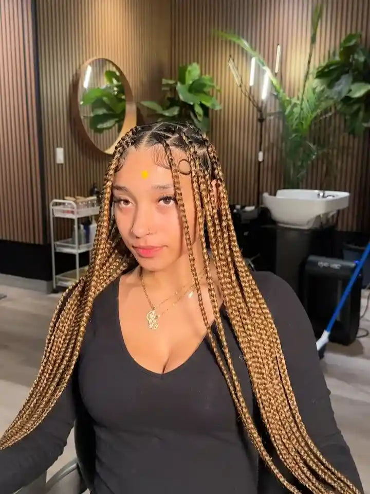 Woman with long braided hair in a salon setting