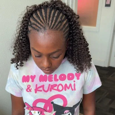 Child with braided hair wearing a shirt with anime characters