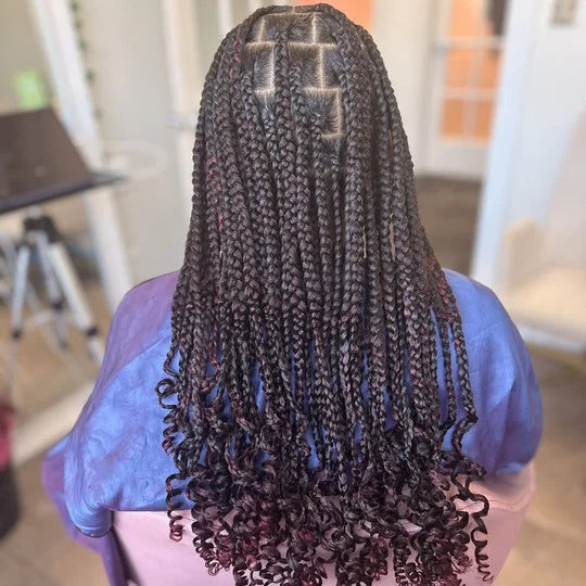 Person with long, braided hair in a salon setting