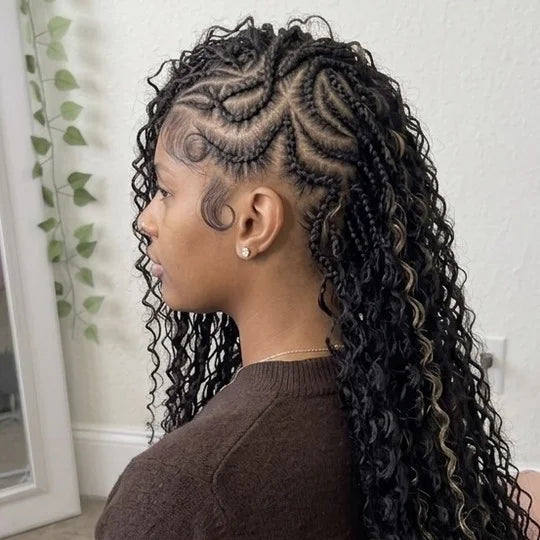 Woman with styled hair in a room with a white wall and plant.