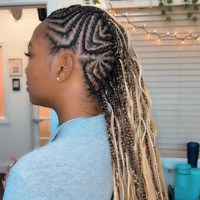 Person with braided hair in a room with decor elements