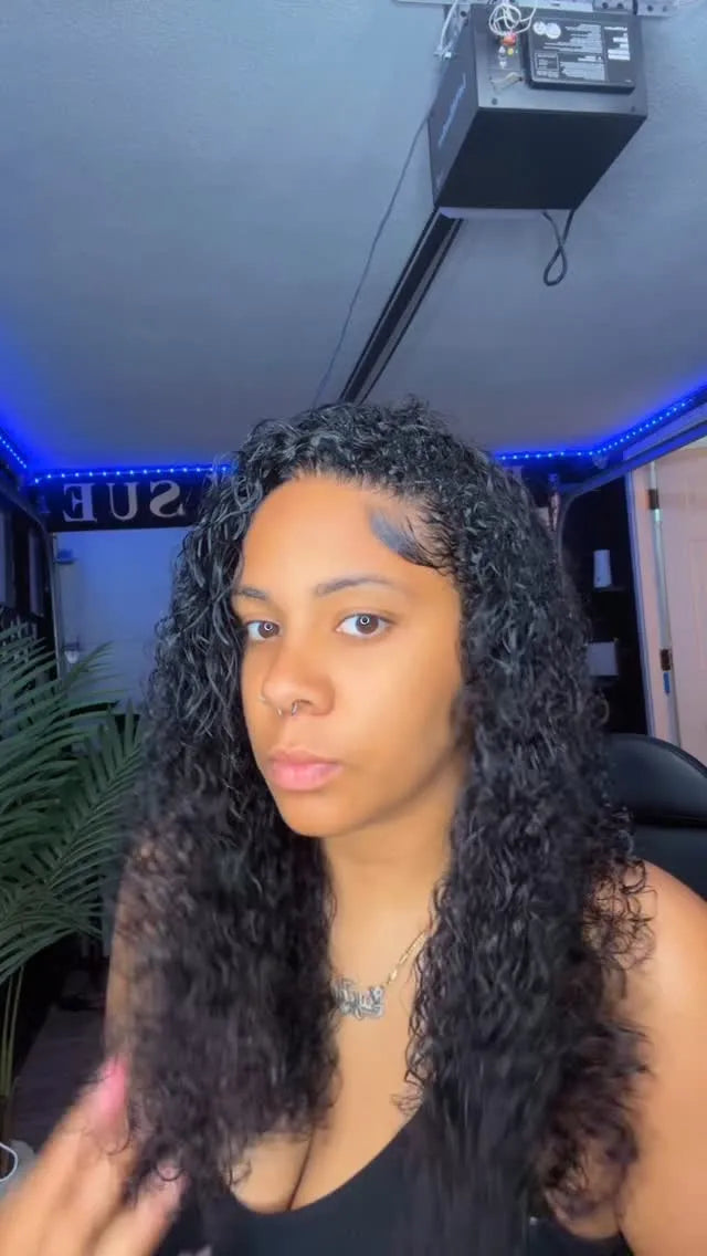 Person with long, curly hair in a room with blue LED lights on the ceiling.