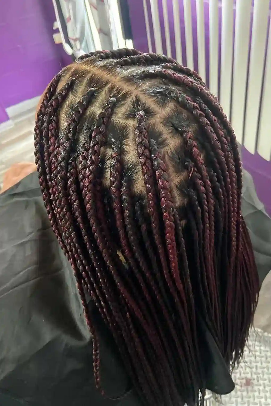 Close-up of braided hair with a purple background