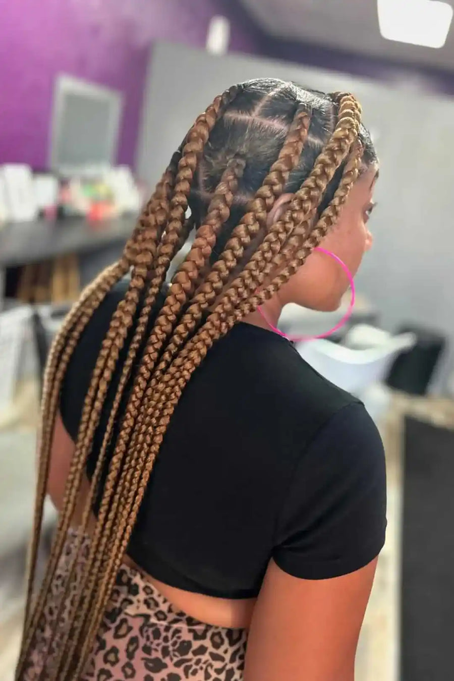 Woman with braided hair in a salon setting