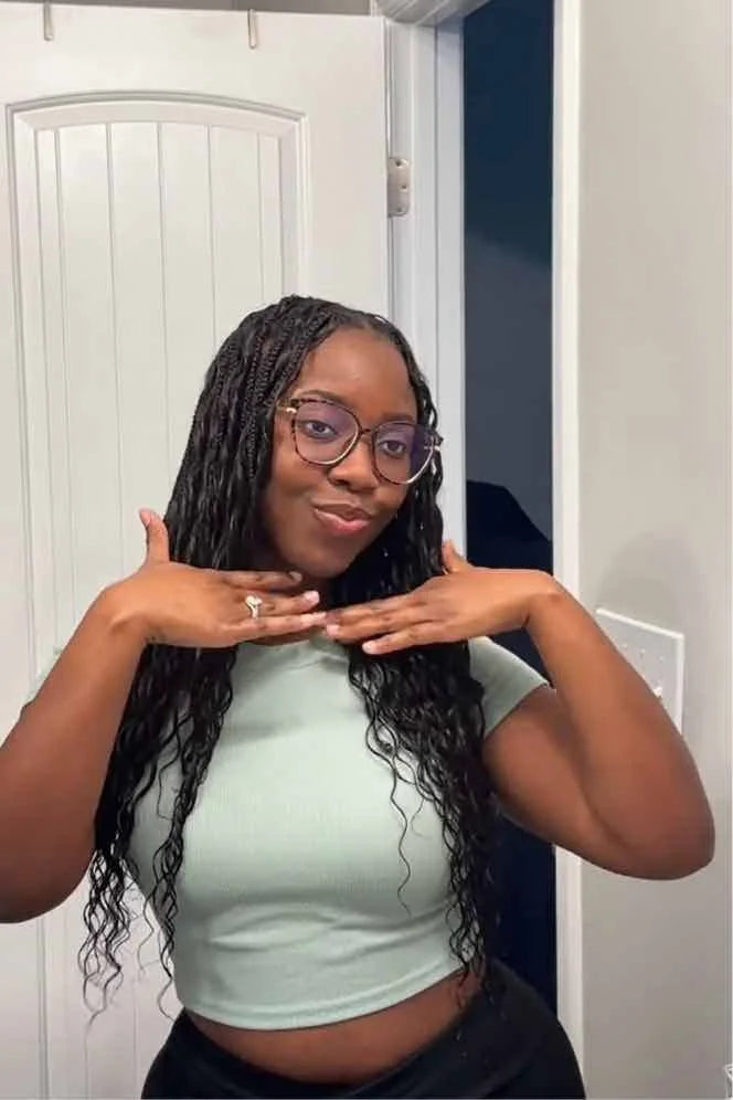 Tiktok influencer amber_699 shows the braiding process of loose deep wave feather crochet hair extension