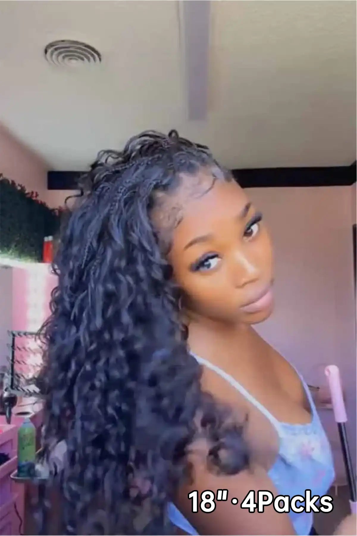 Tiktok influencer binka.luv shows the braiding process of loose deep wave feather crochet hair extension
