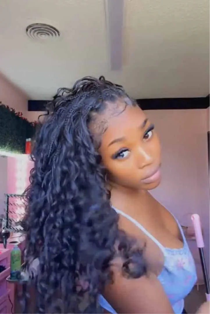 Tiktok influencer binka.luv shows the braiding process of loose deep wave feather crochet hair extension