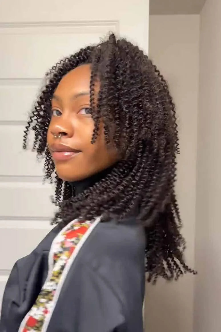Tiktok influencer jairesemaj shows the braiding process of afro kinky curly feather crochet hair extension