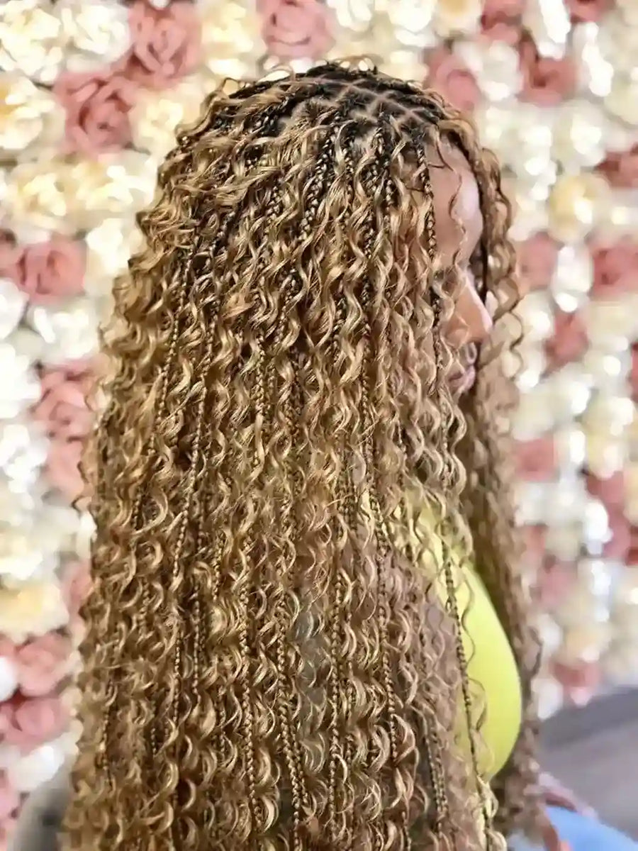 Person with braided hair against a decorative background