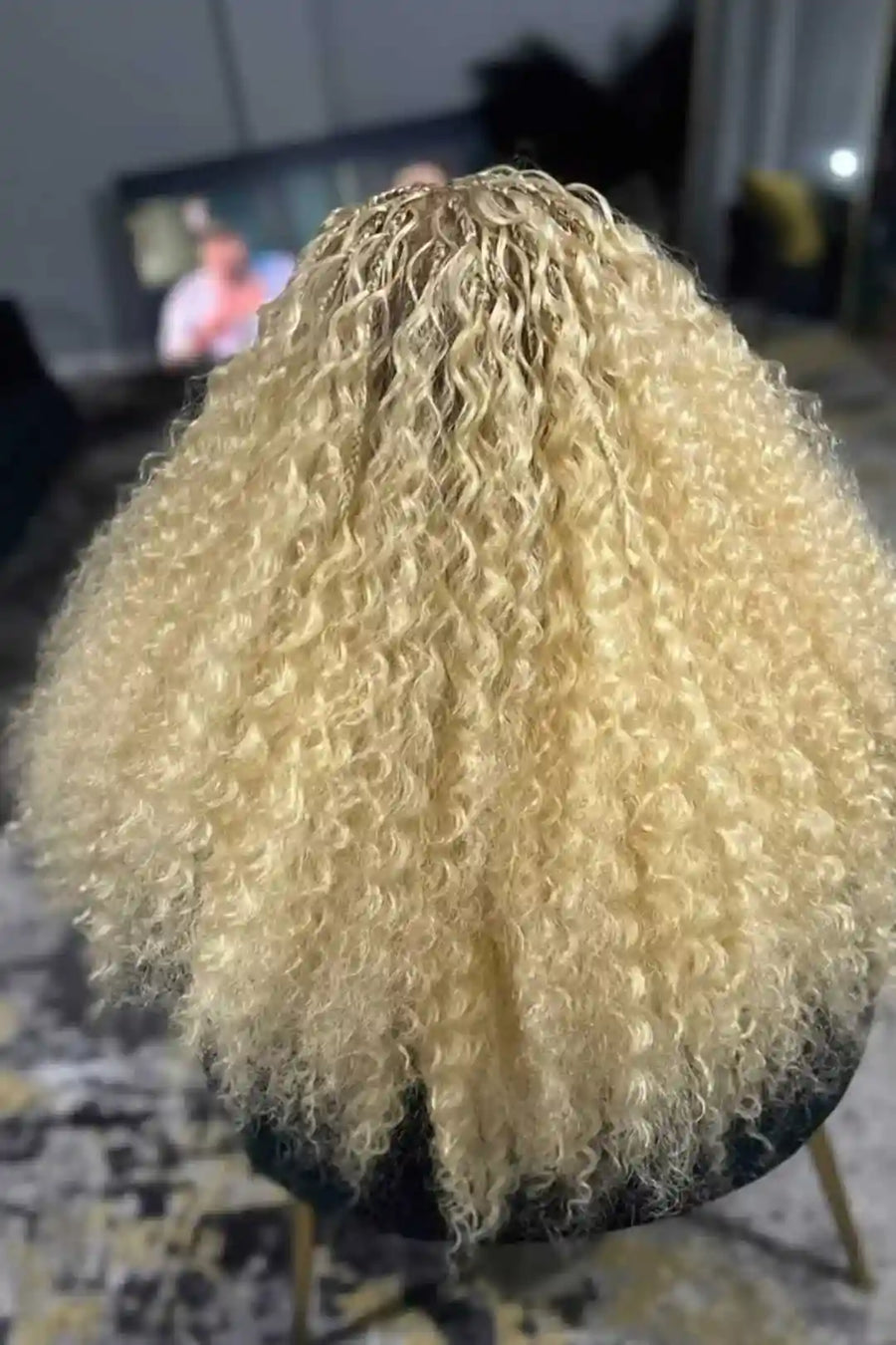 Blonde wig on a mannequin head with a blurred background