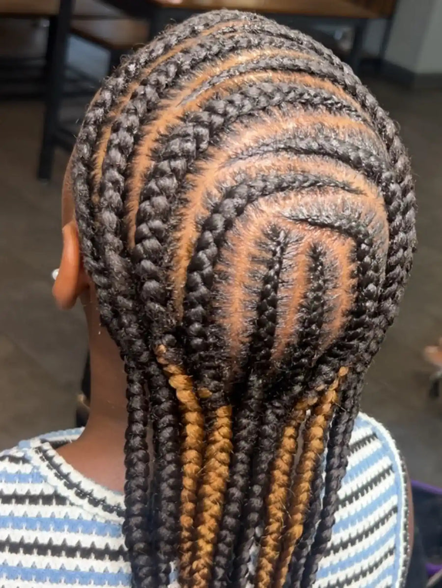 Detailed stitch cornrows with curved geometric patterns and honey blonde accent braids, hairstylist located in Atmore, AL