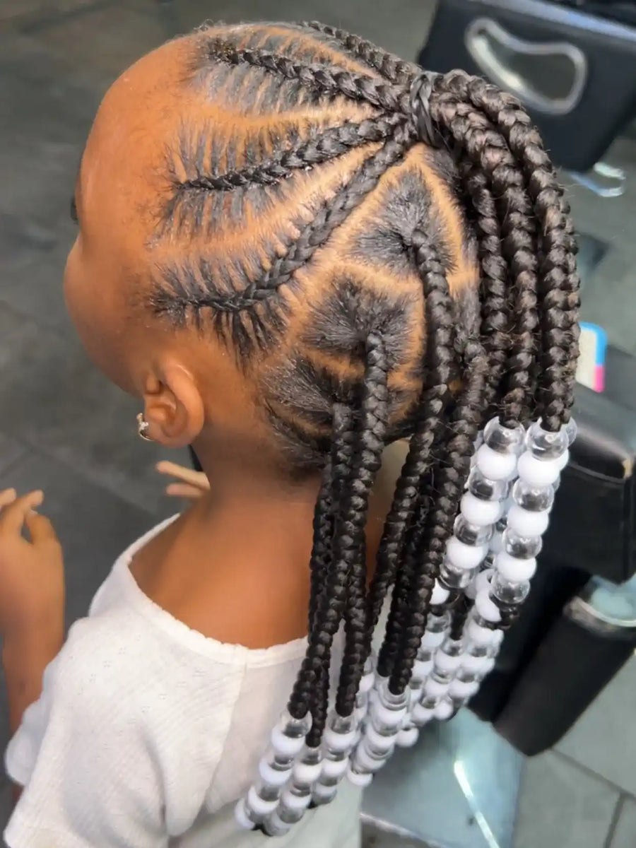 Kids braided ponytail with curved stitch cornrows, geometric parting, and white and silver beads, hairstylist located in Atmore, AL