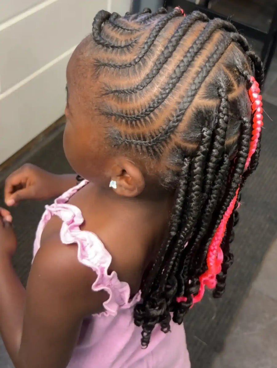 Kids braided ponytail with curved feed-in cornrows, pink accent braids, and curled ends, hairstylist located in Atmore, AL