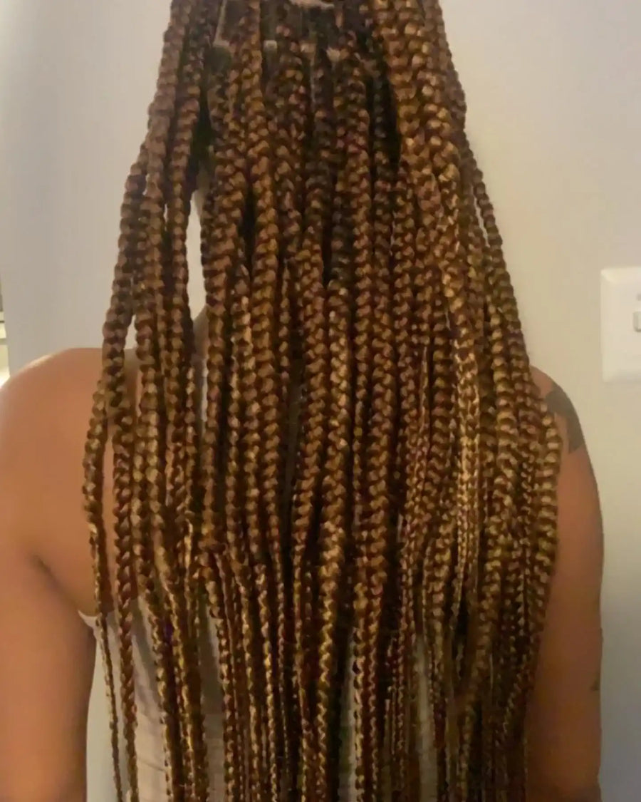 Long honey brown and blonde box braids with a neat, full-length braided finish, Stylist located in Greensboro, NC