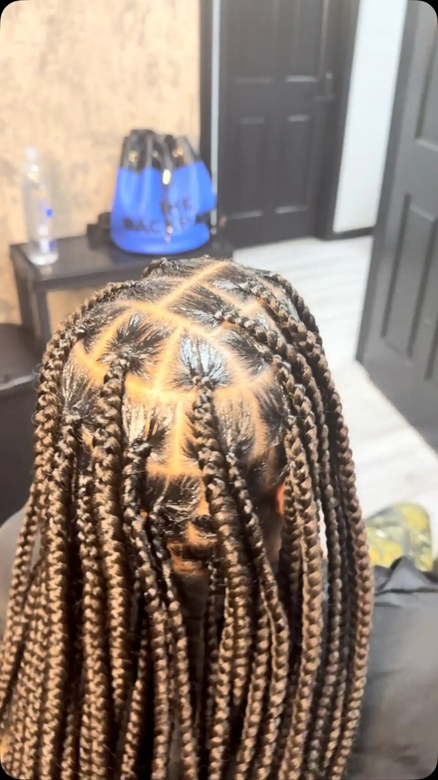 Long brown and blonde box braids with neat square parting and a smooth braided finish, Stylist located in Greensboro, NC