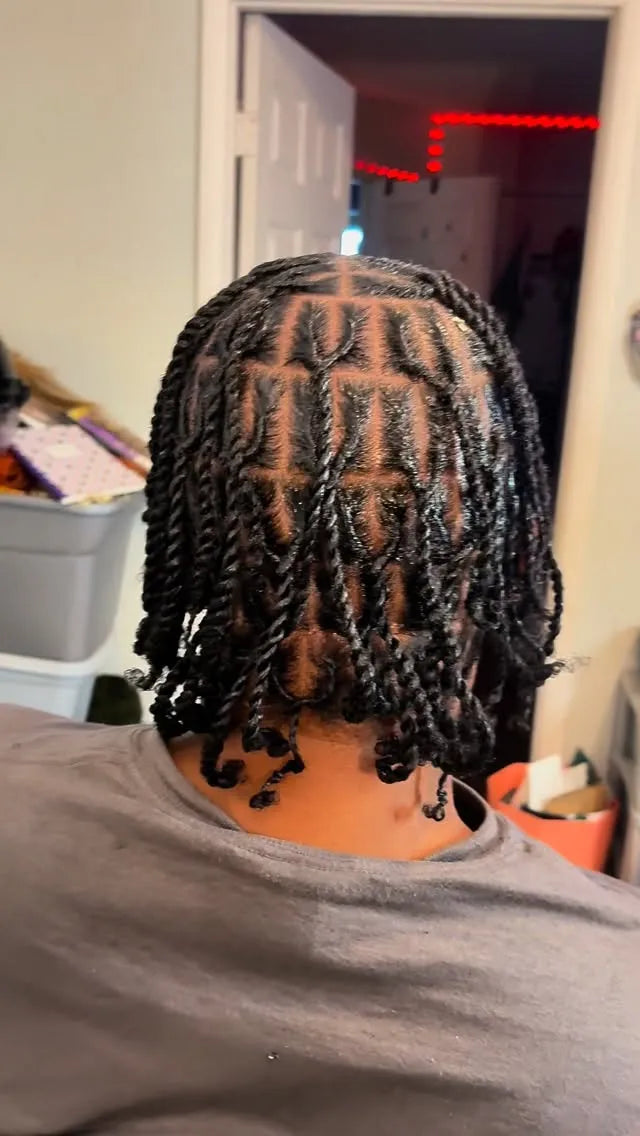 Short black two-strand twists with clean square parts and curled tips, hairstylist located in Hueytown, AL
