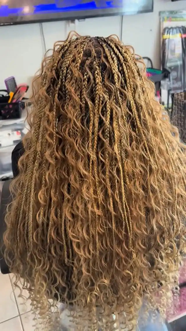 Long honey-blonde boho knotless braids with loose wavy strands and full curly texture, hairstylist located in Hueytown, AL