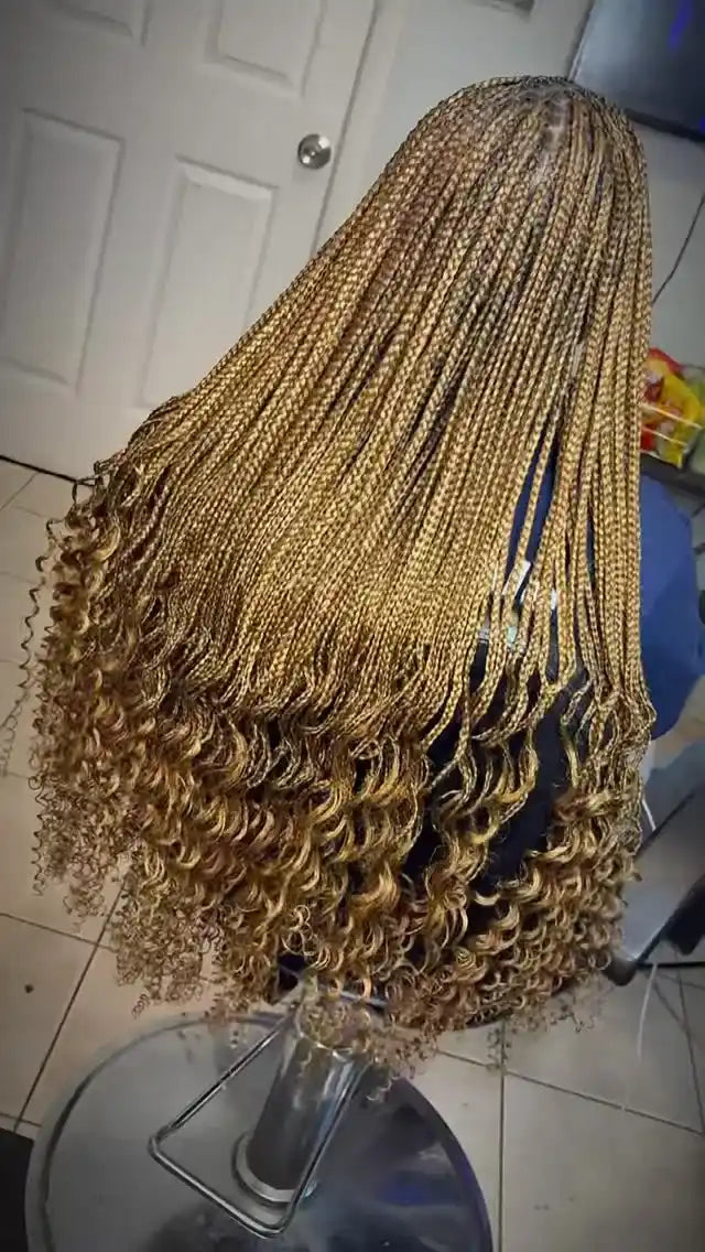 Long blonde micro box braids with curled ends and a layered finish, hairstylist located in Hueytown, AL