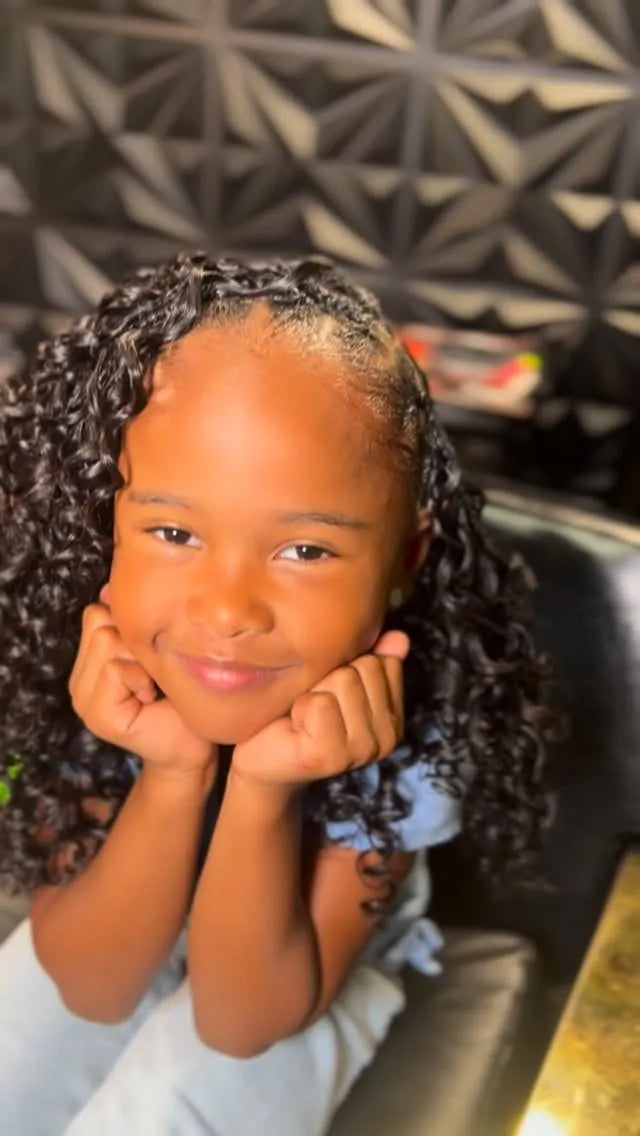 Side-swept cornrow braids with voluminous black spiral curls in a cute children's hairstyle, Stylist located in Houston, TX