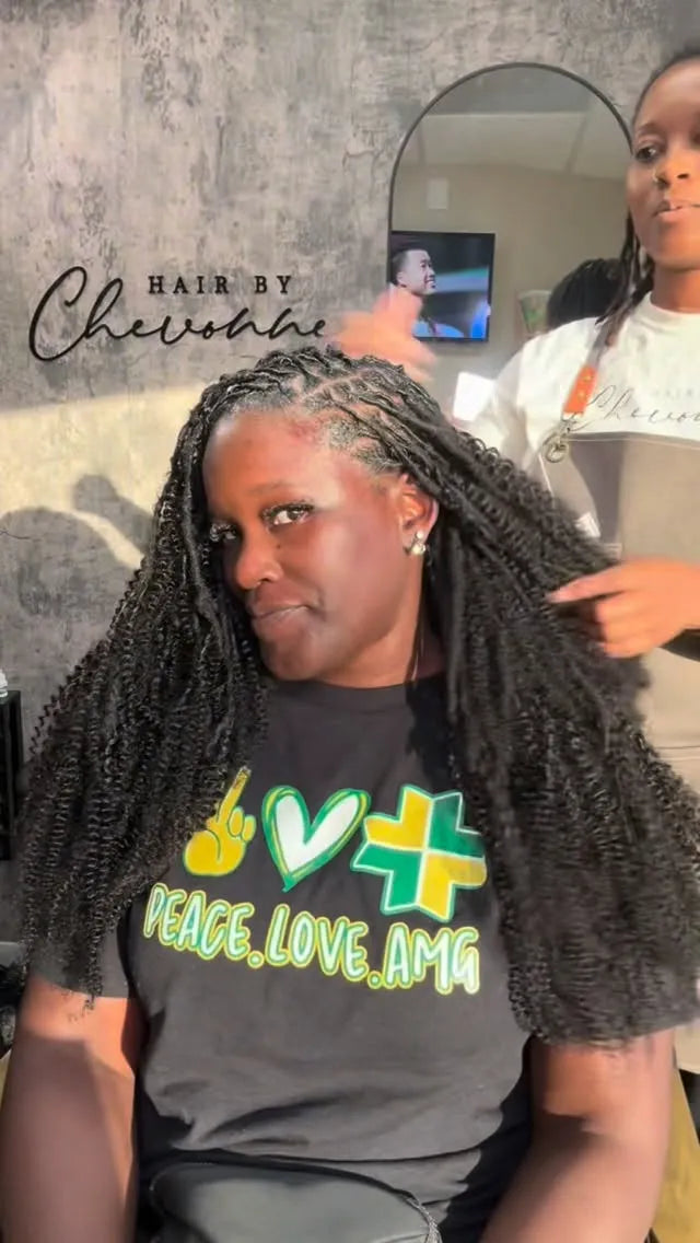 Feed-in cornrow braids styled into a high curly ponytail with defined black curls, Stylist located in Houston, TX