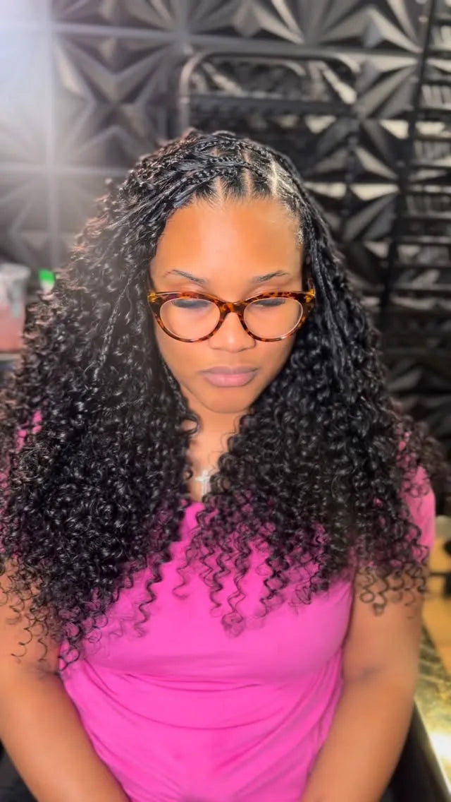 Black curly hairstyle with neatly braided cornrows at the crown and full, defined curls, Stylist located in Houston, TX