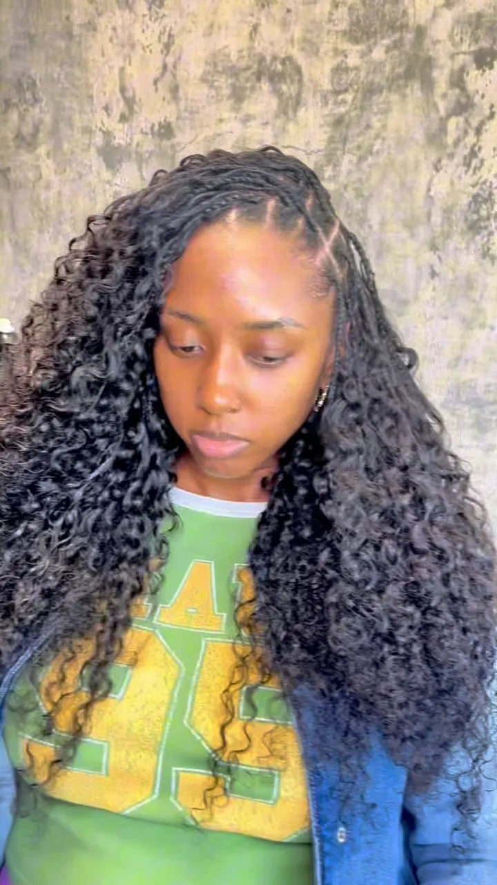 Side-parted feed-in braids blended with long, voluminous black curly extensions, Stylist located in Houston, TX