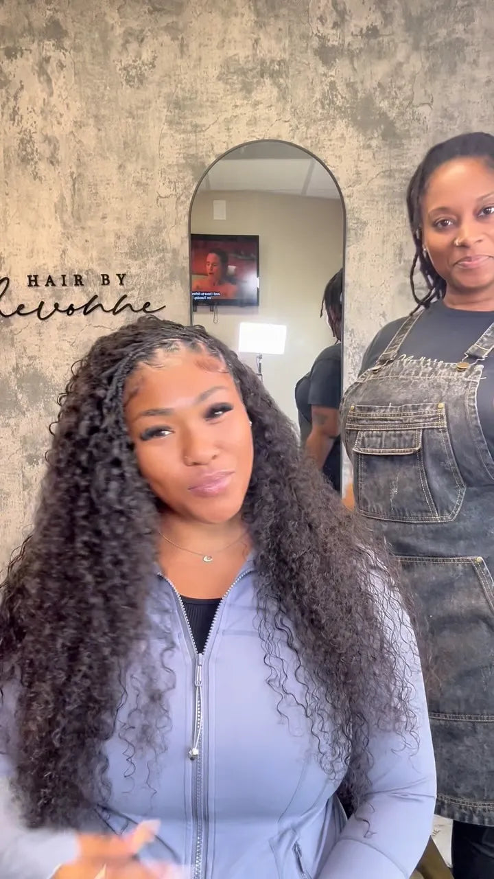 Long black curly faux locs with braided roots and loose textured curls, Stylist located in Houston, TX