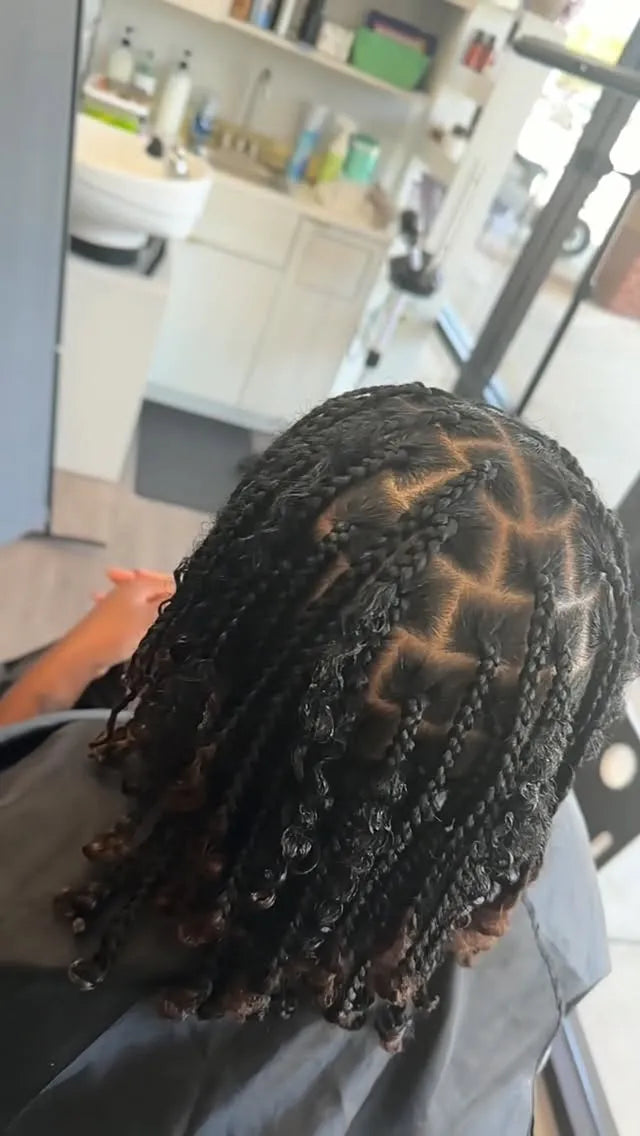 Short boho box braids with curly ends and clean square parts, hairstylist located in Morrisville, North Carolina