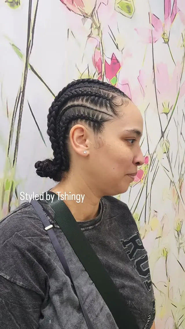 Feed-in cornrows braided back into a low bun with neat curved parts, hairstylist located in Morrisville, North Carolina