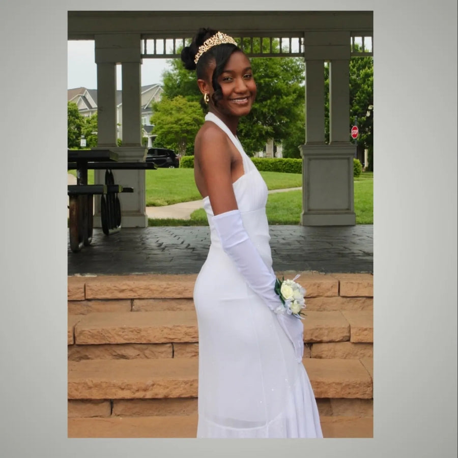 Formal high bun updo with side-swept curl and tiara accessory, hairstylist located in Morrisville, North Carolina